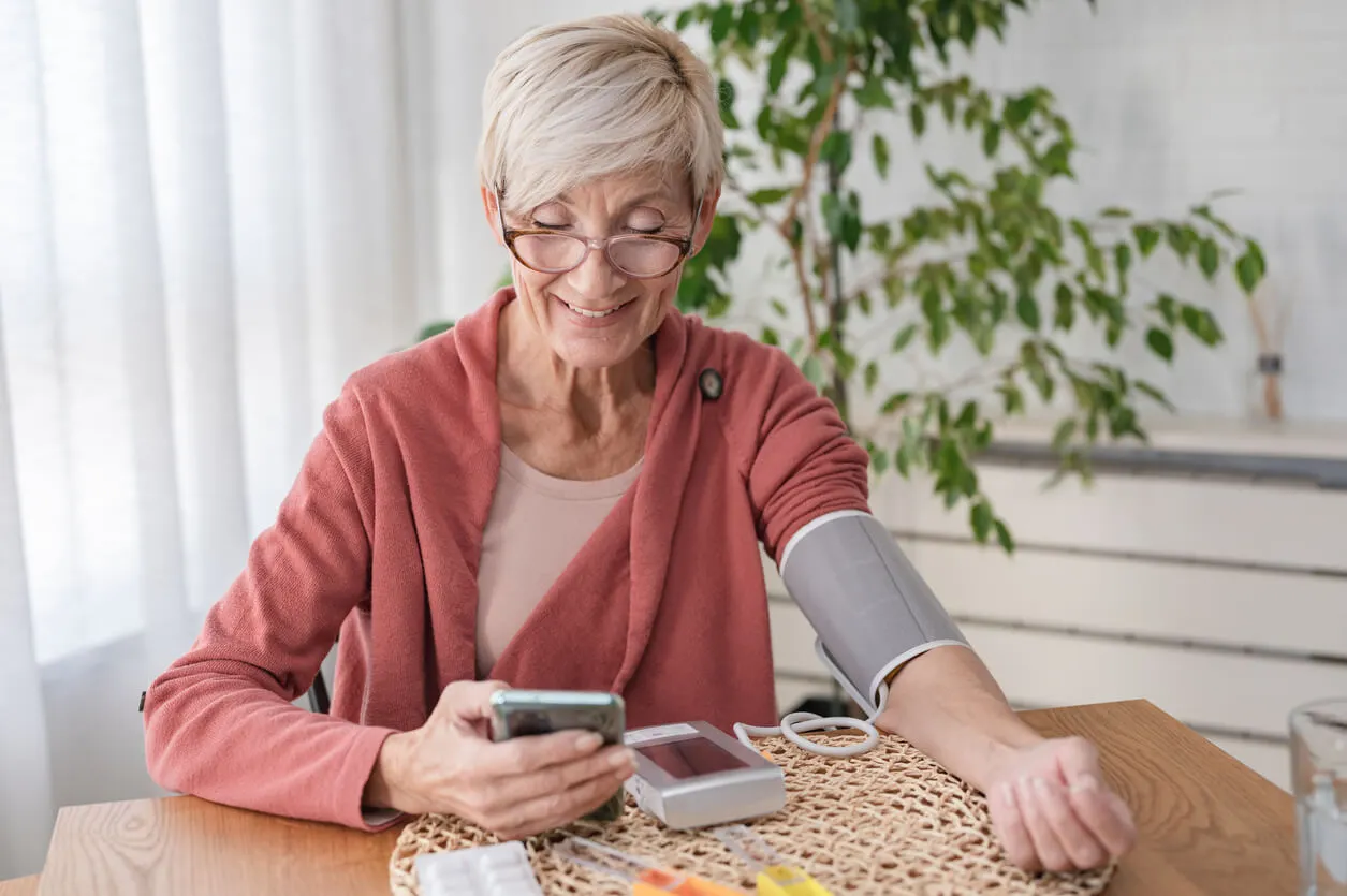 Patient using cellular powered blood pressure cuff with remote patient monitoring program