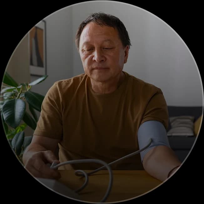 Rural health patient with hypertension taking daily blood pressure reading for preventative care.
