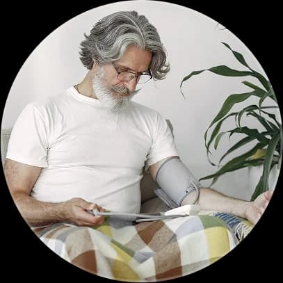 Man using blood pressure cuff with remote patient monitoring