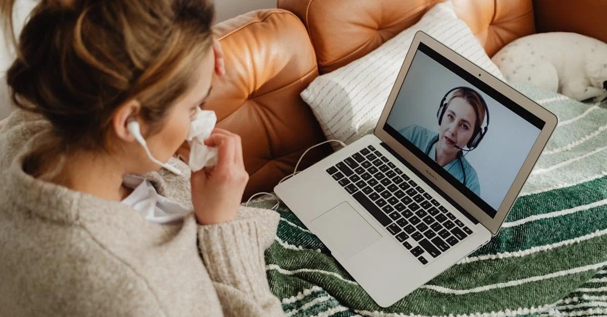 Woman having video call with healthcare provider on laptop while sitting on couch for cost containment healthcare.
