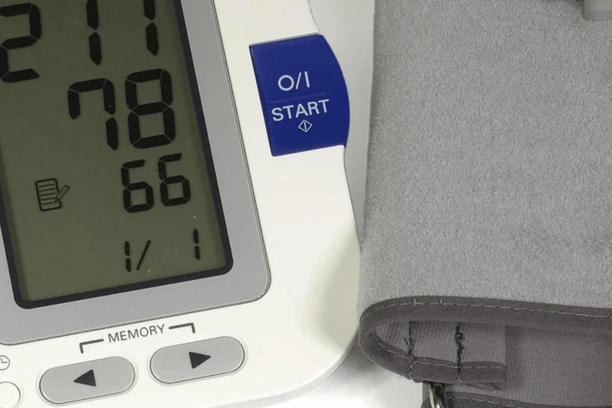Close-up of digital blood pressure monitor showing readings.