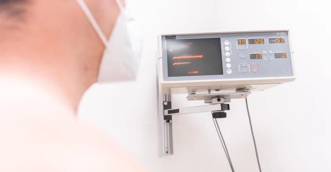 Healthcare provider reviewing remote patient monitoring heart failure data on diagnostic display screen.