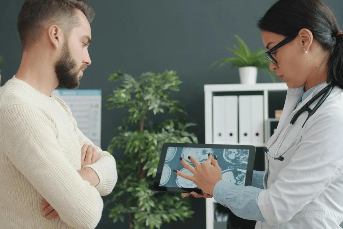 Doctor reviews a medical scan with a patient, highlighting personalized healthcare and attentive medical consultation.